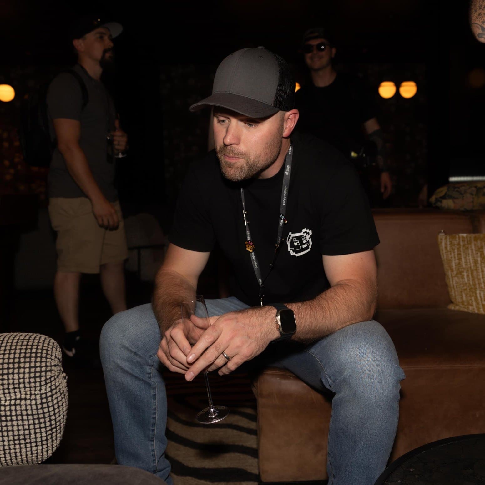 Joshua Lambert, publicly known as LambMetaX (@LambMetaX), seated in a lounge wearing a grey cap and a Doginal Dogs t-shirt